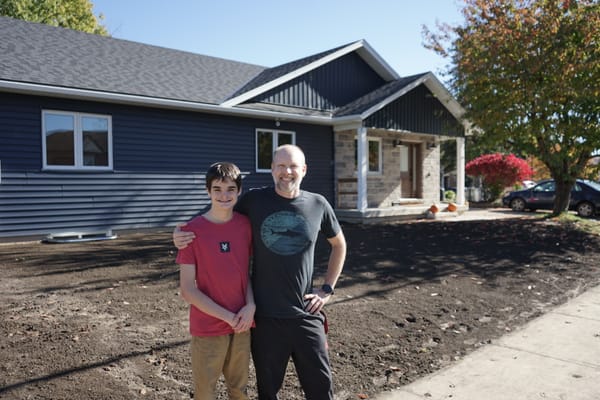 A year after fire, family opens rebuilt home to host neighbours
