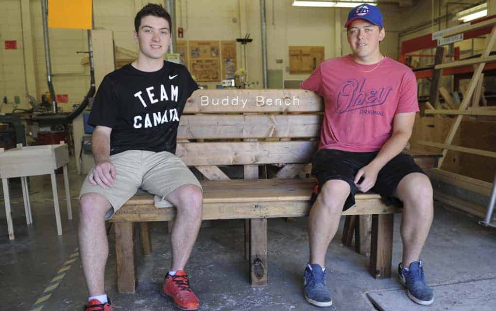 Students make benches that are designed to help shy kids get more involved