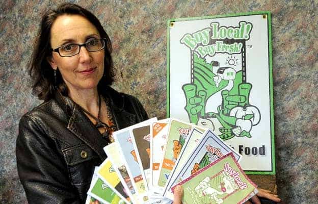 Foodlink manager Anna Contini displays more than a decade's worth of local food maps.[will sloan / the observer]