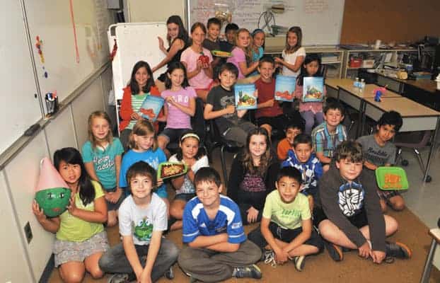 Debbie Pavlove’s Breslau PS class hold up Food For Thought, the published book on nutrition they created, from cover to cover, just in time for the end of their fourth-grade school year. [elena maystruk / the observer]