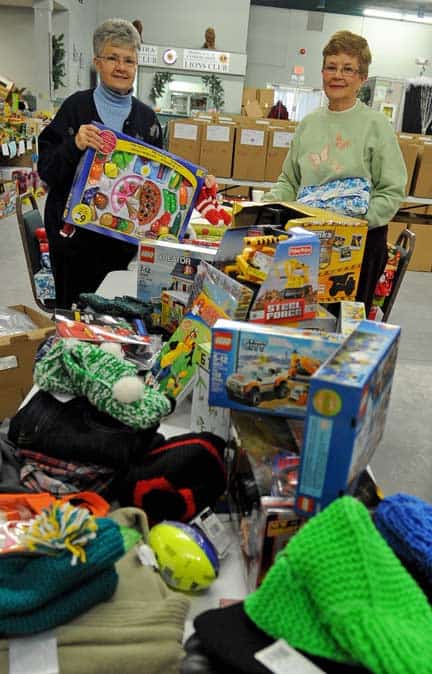 Judy Meyer (left) and Nancy Cooper hold up some of the items donated to this year’s toy drive. 