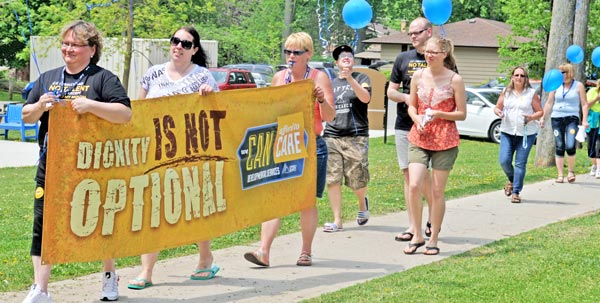 Developmental service workers from Elmira did the Dignity Walk to create awareness about the funding crisis in their field.[Whitney Neilson / The Observer]