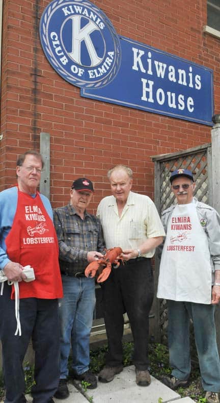 Elmira Kiwanis Club members Tom Edge, Lorne Martin, Ernie Robertson and Eugene Read have a trusty mascot handy as they prepare for the annual lobster dinner on May 31.[Scott Barber / The Observer]