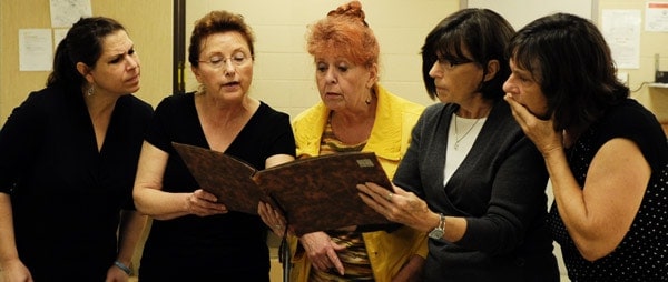 Jane Koehler, Mary Ducklow, Susan Mitchell, Dian Naish and Nancy Croth practice their roles as the sisters and cousins who must clean out their dead mother’s house in K-W Silver Star’s new musical, One Step Forward. Below, Donna Kuehl sings as one of the memory singers.[Whitney Neilson / The Observer]