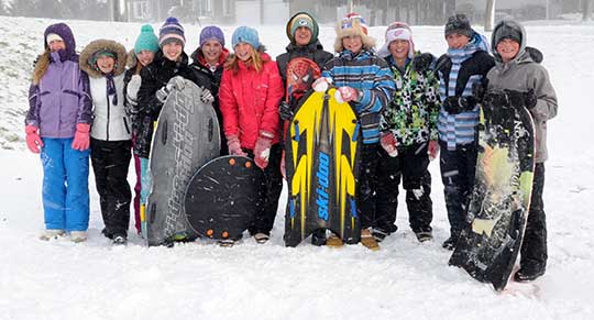 Students in Wellesley took advantage of a snow day on Nov. 18, sledding behind the St. Clements Arena. From left, Jade Lipczynski, Nikki Beam, Jessie Herbison, Olivia Bolender, Taylor Hartung, Abbey Brick, Lucas Economides, Nolan Hislop, Jake Voisin, Zac Good, and Liam Dietrich.[Whitney Neilson / the observer]