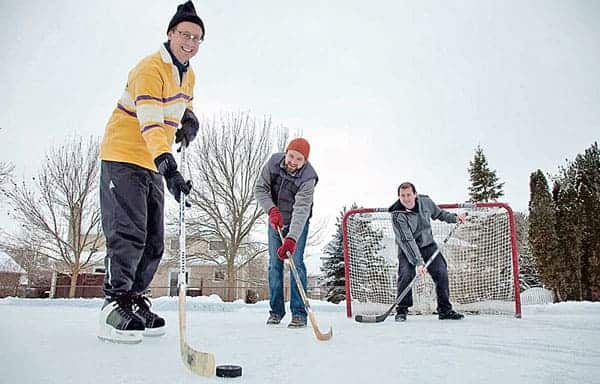 Robert McLeman, Colin Robertson, and Haydn Lawrence test out a backyard rink, which can be added to the map on RinkWatch.[Submitted]