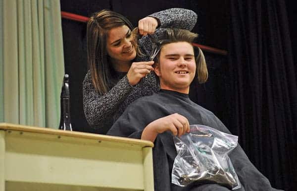 Parker Winfield said goodbye to his long hair on Wednesday as he donated it to Locks of Love after growing it out since 2013.  [Whitney Neilson / The Observer]