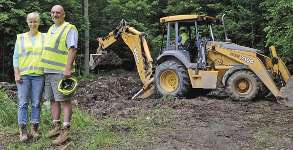 Michelle Shannon and John Weber are thankful Safety Kleen, Aevitas and Waste Management chipped in to remove 24 barrels of hazardous materials illegally dumped at their sugar bush near Conestogo.[Scott Barber / The Observer]