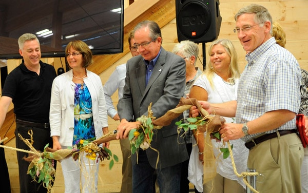 MPP Michael Harris, Mayor Sandy Shantz, Minister of Agriculture, Food, and Rural Affairs Jeff Leal, and Waterloo Region Chair Ken Seiling cut the burlap garland to officially open the St. Jacobs Farmers’ Market’s newest building on Sept. 1.[Whitney Neilson / The Observer]