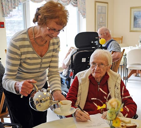 The Elmira Chartwell Retirement Residence gathered for a worldwide tea part on Mar. 16 in an attempt to break the Guinness World Record for largest multi-site tea party in conjunction with other healthcare facilities around the world. Here, Betty Ertel serves tea to Birthe Falk.[Whitney Neilson / The Observer]