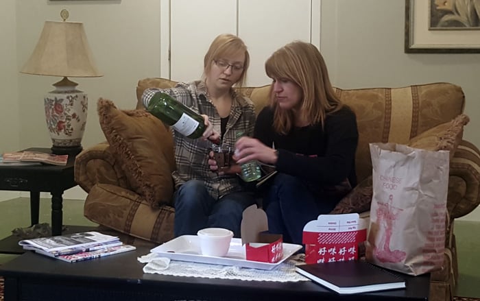 Sarah Kipp and Lori Hoelscher, as sisters Heather and Nicki, share a drink during a rehearsal for Theatre Wellesley’s The Second Time Around, premiering this weekend.[Submitted]