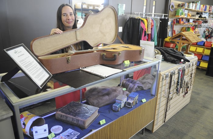 Julie Mikel with some of the items up for bid at the new silent auction launched last week at Woolwich Community Services’ Thrift Shop in Elmira.[Whitney Neilson / The Observer]
