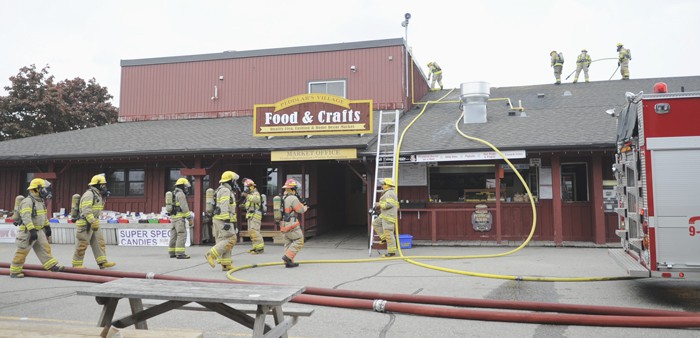 An all-too-familiar scene, fire crews from St. Jacobs, Elmira, Conestogo, and Breslau were called to a fire at the St. Jacobs Farmers’ Market May 26, this time to the roof of the Peddlar’s Village building.[Whitney Neilson / The Observer]