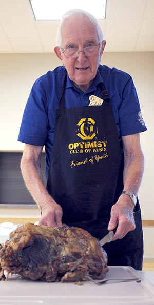 Ray Grose carves up some of his barbequed beef ahead of last week’s community dinner in Alma, where he’s been a fixture for more than three decades.[Liz Bevan / The Observer]