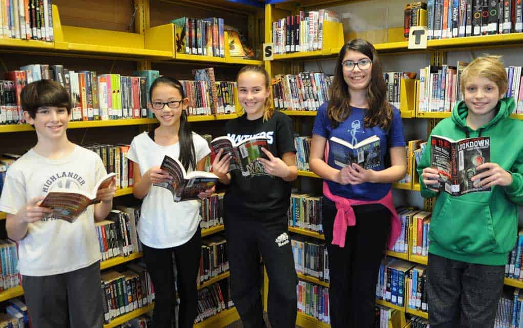 Kiwanis Club donations help stock shelves of school libraries in Woolwich