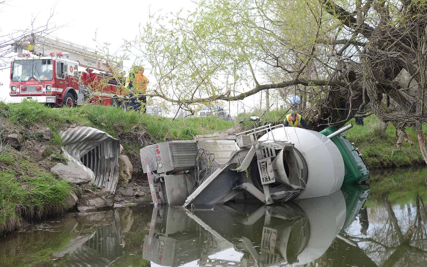 Cement truck rolls into river