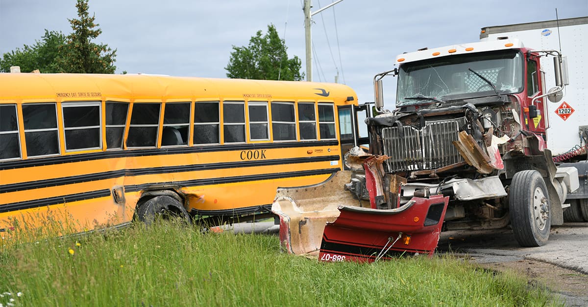 Collision between a school bus and a transport truck